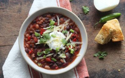easy three bean chili with toppings and bread with pepper and onion