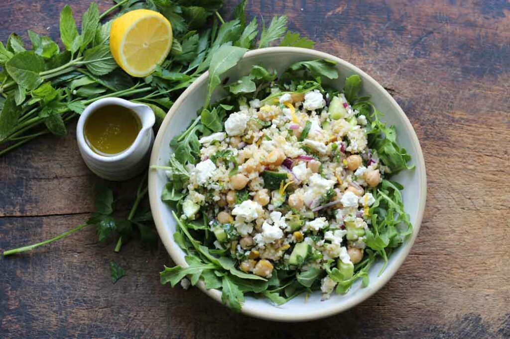 chopped jennifer aniston salad on a bed of greens