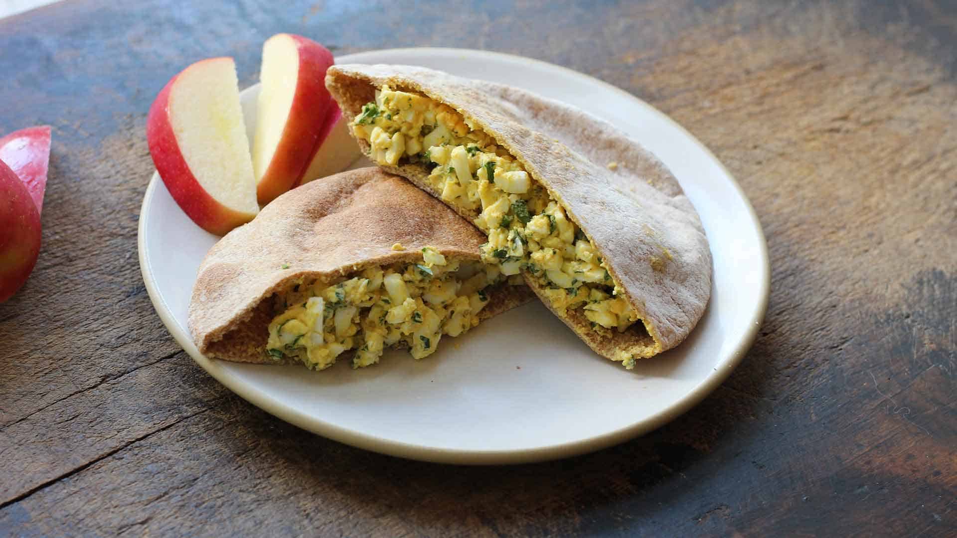 egg salad in whole-wheat pita with feta and apple on the side