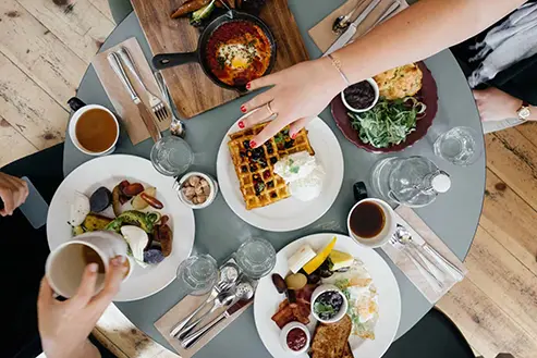 A tabletop breakfast with several mediterranean dishes.